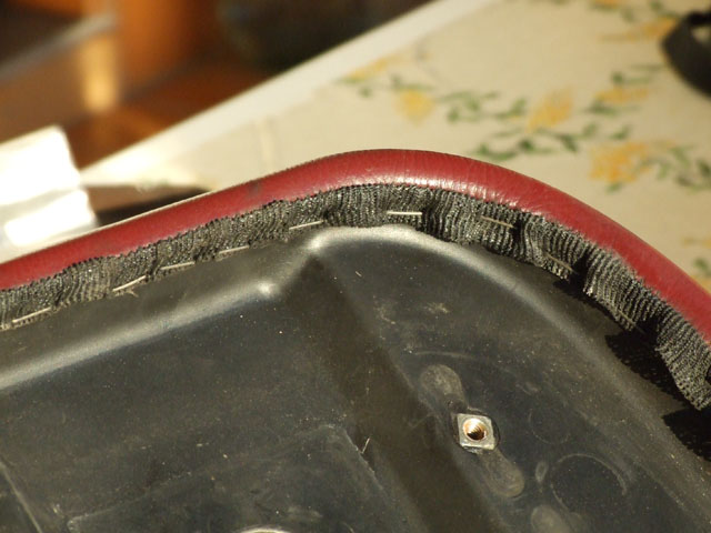 Remove the staples that hold the cover to the seat