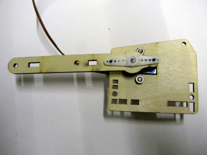 Attaching the first part of the first segment of the robotic arm to its servo Attaching the first part of the first segment of the robotic arm to its servo