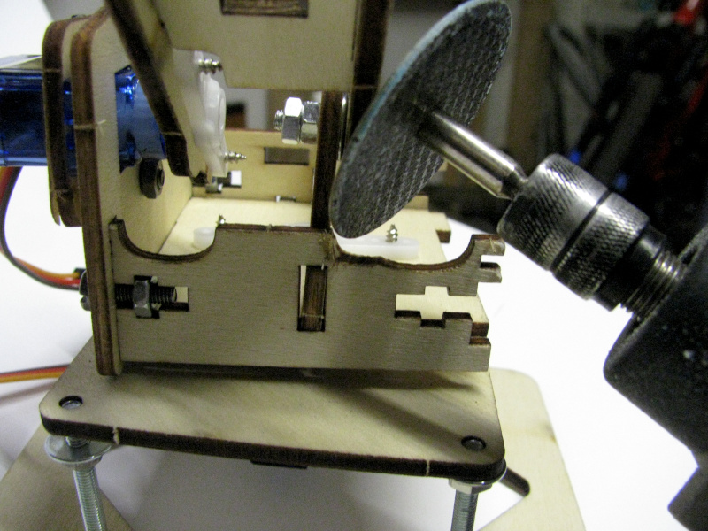 With a mini-drill (similar to Dremel) I removed the excess part that was blocking the arm With a mini-drill (similar to Dremel) I removed the excess part that was blocking the arm