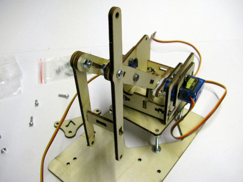 Fixing the second segment of the robotic arm with screws, nuts and locknuts Fixing the second segment of the robotic arm with screws, nuts and locknuts