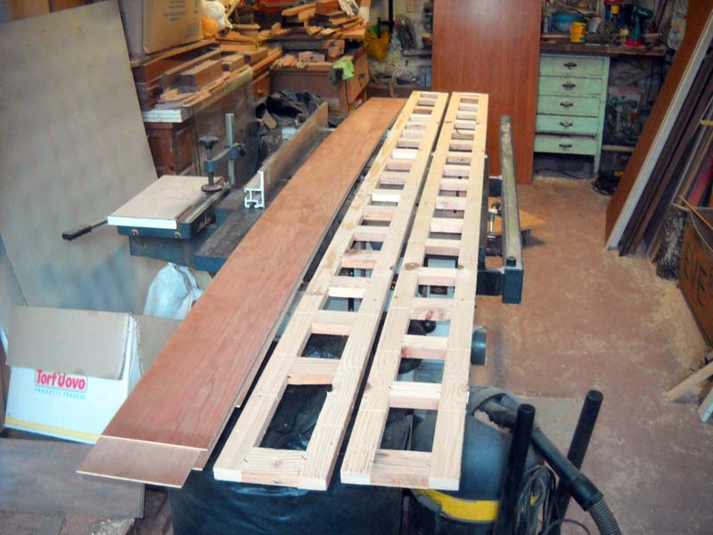 The structure is completed by gluing pieces of plywood ennobled with cherry wood