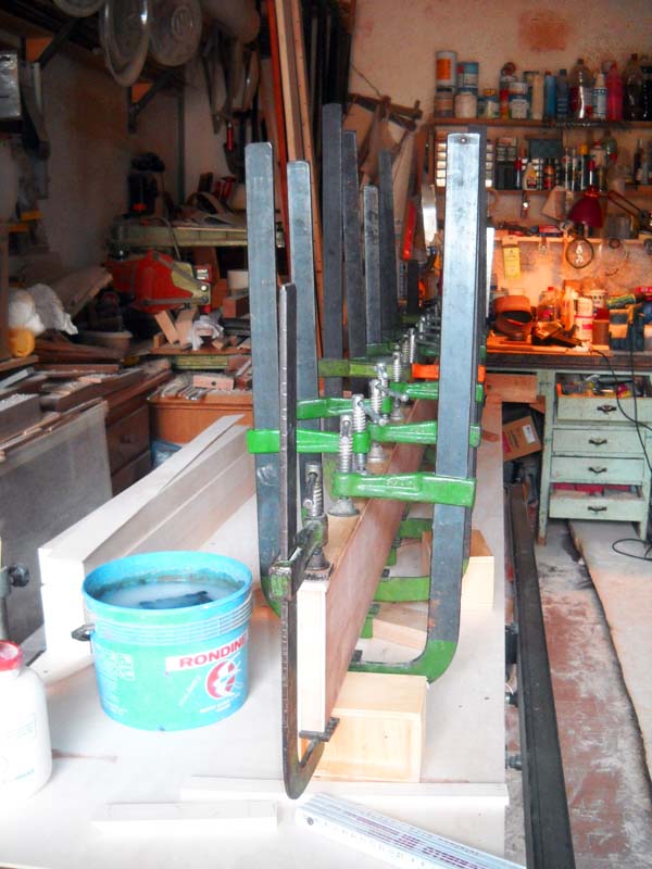 The cover strips are glued and held under pressure with clamps